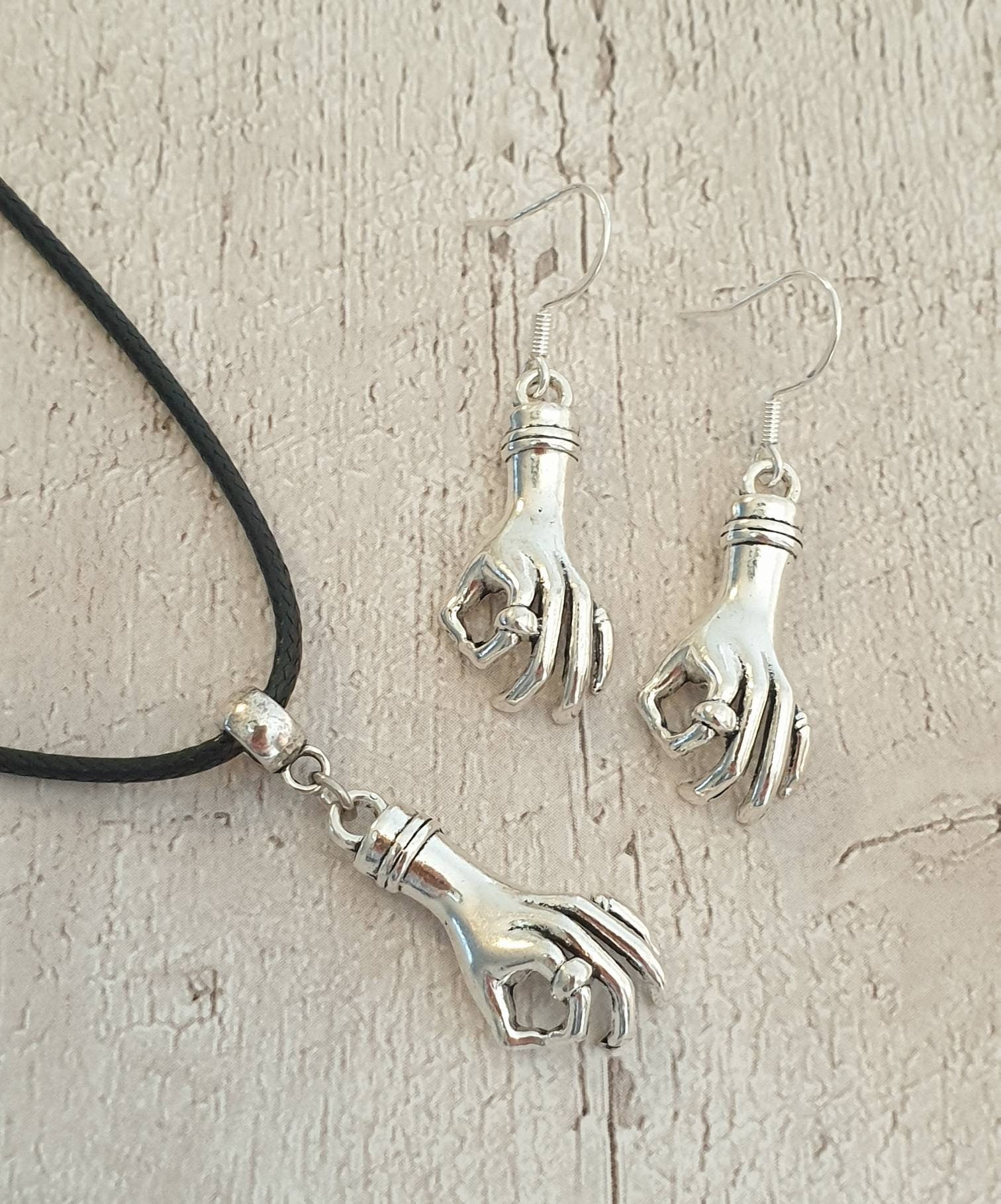 Handmade Antique Silver Wednesday Inspired Thing Hand Charm Jewellery Set, Dangly Earring And Necklace Set In Gift Bag, Cord Or Chain Option - Premium  from Etsy - Just £8.99! Shop now at Uniquely Holt