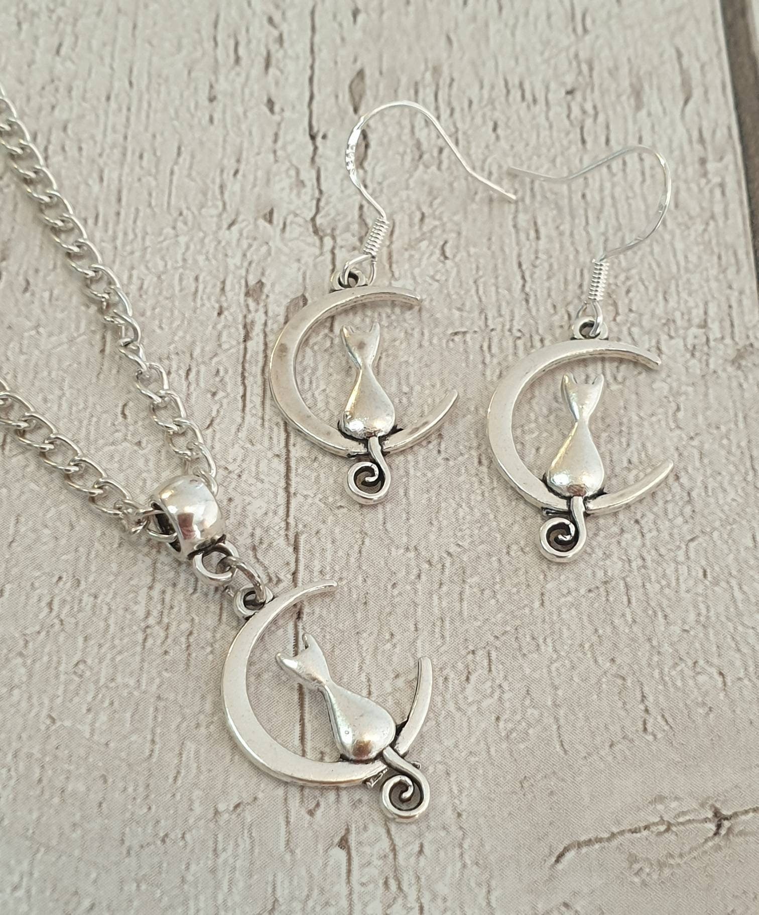 Handmade Antique Silver Cat On Moon Charm Jewellery Set, Dangly Earring And Necklace Set In Gift Bag, Cat Lover, Cord Or Chain Option - Premium  from Etsy - Just £8.99! Shop now at Uniquely Holt