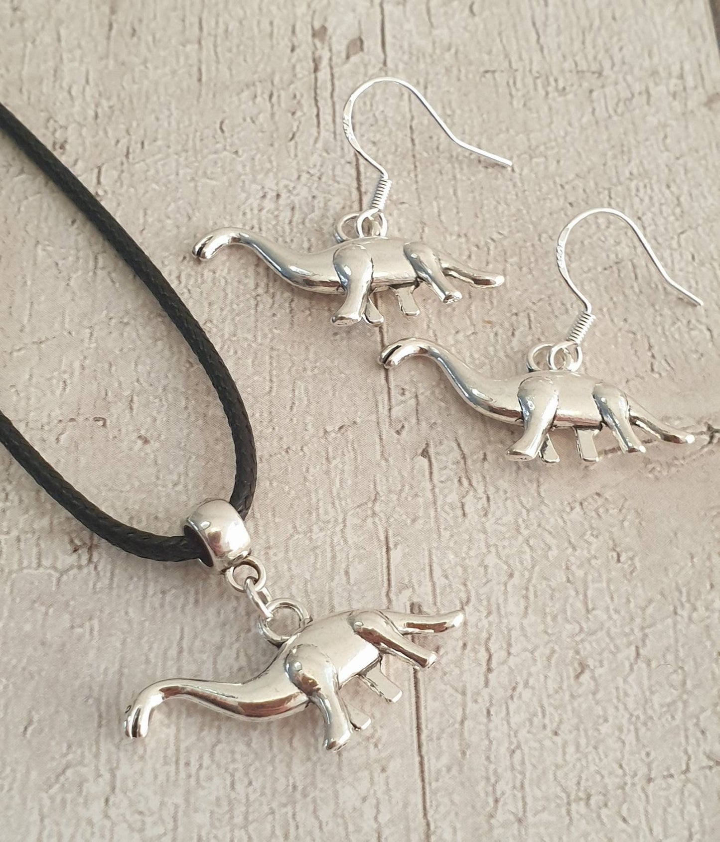 Handmade Antique Silver Dinosaur Charm Jewellery Set, Dangly Earring And Necklace Set In Gift Bag, Cord Or Chain Option - Premium  from Etsy - Just £8.99! Shop now at Uniquely Holt
