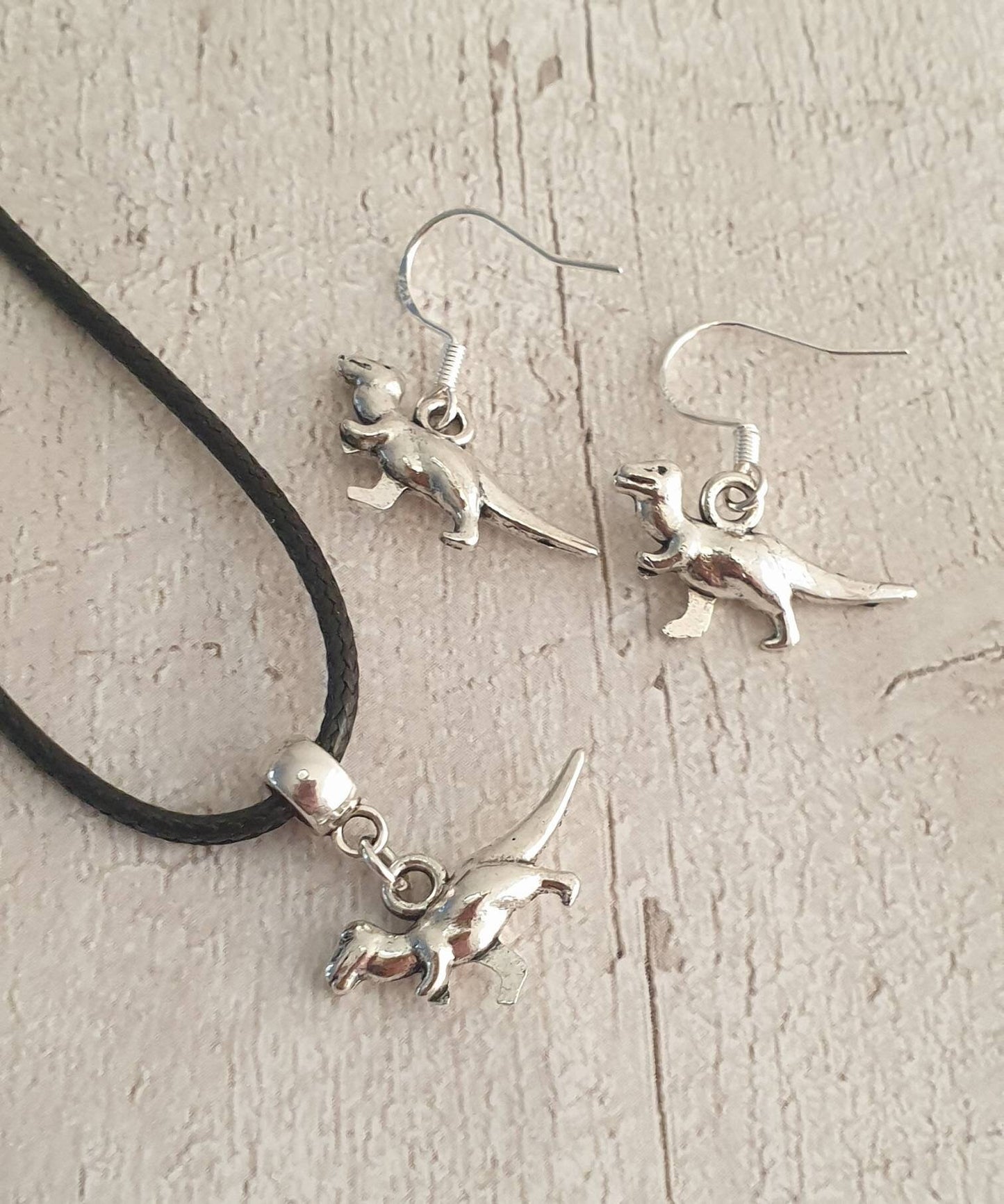 Handmade Antique Silver Dinosaur Charm Jewellery Set, Dangly Earring And Necklace Set In Gift Bag, Cord Or Chain Options - Premium  from Etsy - Just £8.99! Shop now at Uniquely Holt